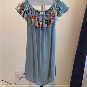 Woman’s off the shoulder blue jean dress